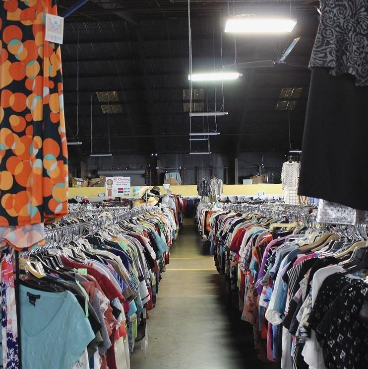 Aisle of donated clothes for sale at a Vinnies thrift store