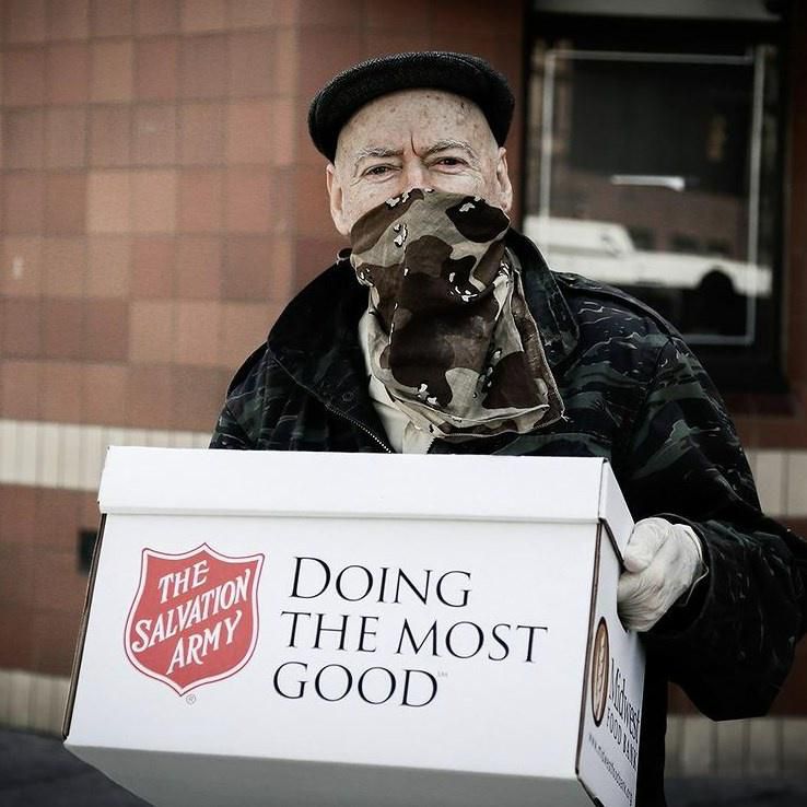 Eldely man donating goods at a Salvation Army drop point